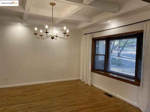 a view of staircase with wooden floor and white walls