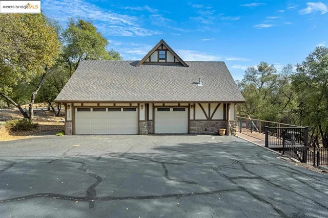 a front view of a house with a garden and pathway