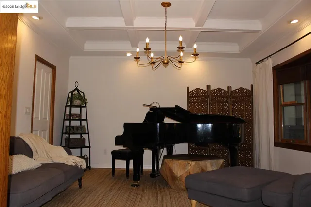 a spacious bedroom with bed and a chandelier
