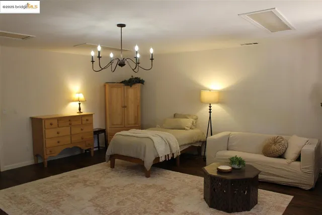 a bedroom with furniture and a window