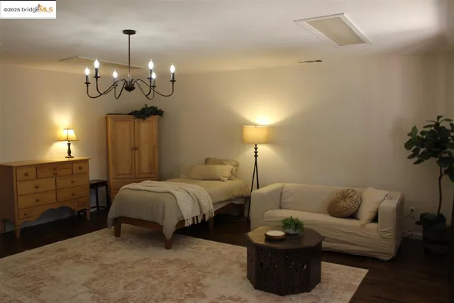 a bathroom with a granite countertop toilet a sink and a mirror