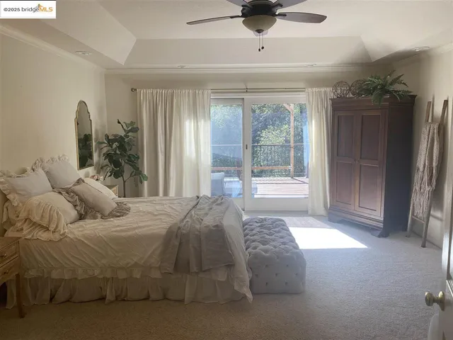 a spacious bedroom with a bed and a mirror
