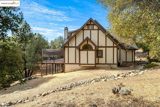 a view of a house with snow on the road