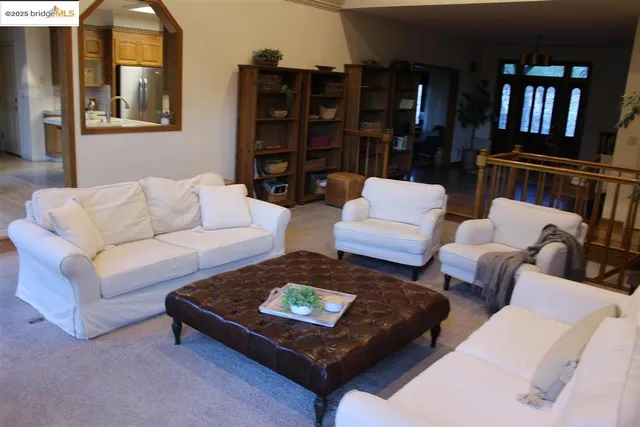 a living room with furniture a lamp and a bookshelf