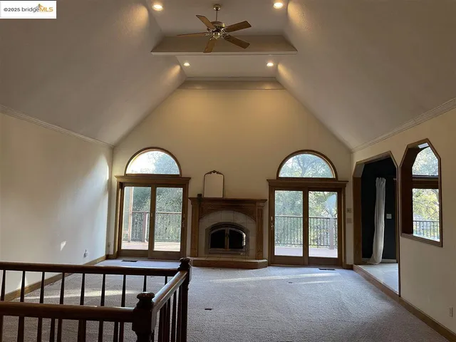 a view of a livingroom with a fireplace and window