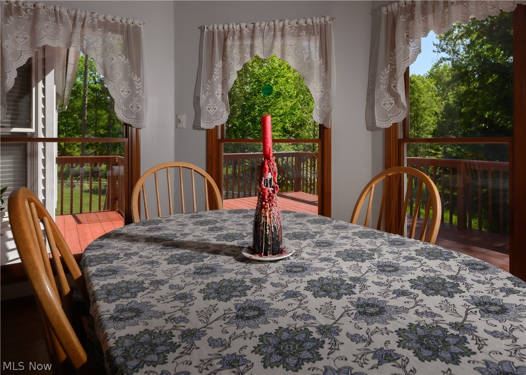 8745 Broadview Road Broadview Heights, OH 44147 - Photo 6 of 49 Dining area featuring multiple windows, wood trim, and a red-toned deck