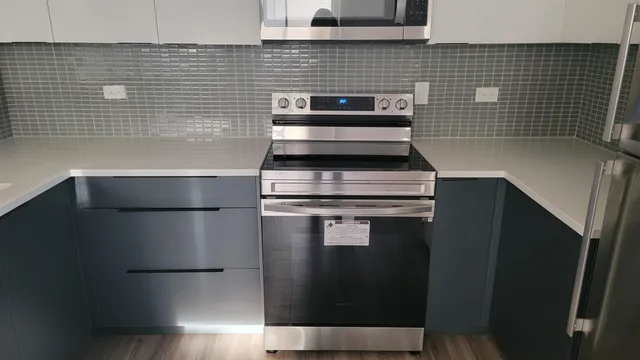 a stove top oven sitting inside of a kitchen