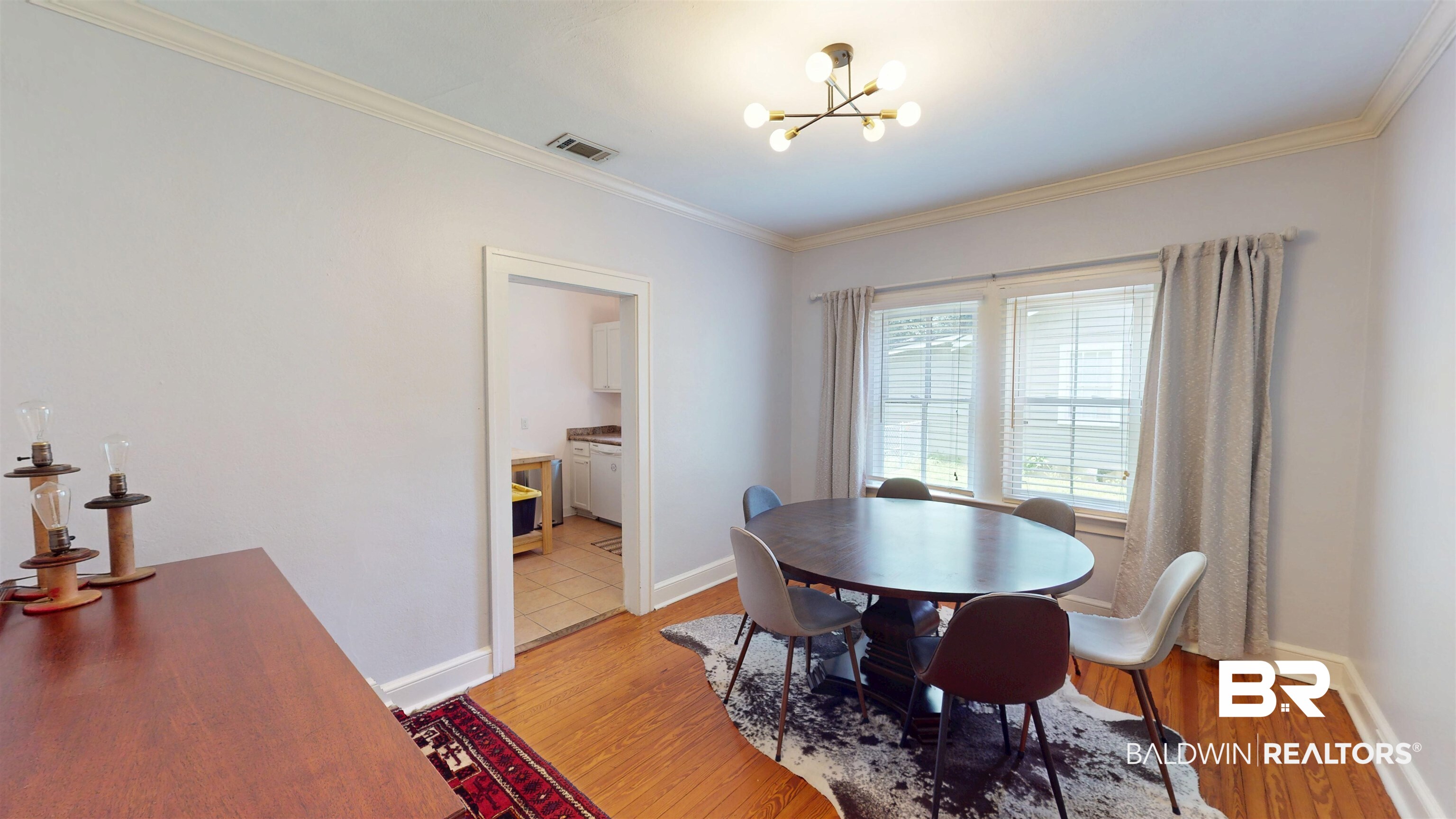266 Westwood Street Mobile, AL 36606 - Photo 10 of 34 Dining space featuring a chandelier, light wood-type flooring, ornamental molding, and baseboards