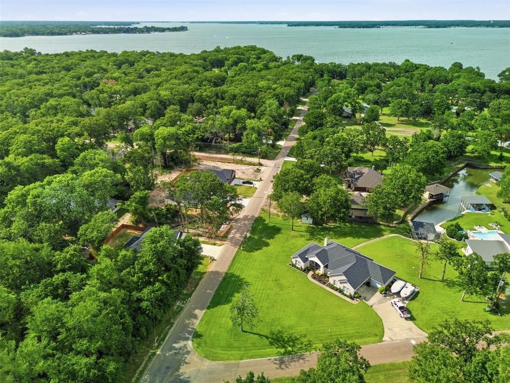 429 Waterboard Road Trinidad, TX 75163 - Photo 4 of 25 Expansive property featuring a meticulously maintained green lawn and a paved driveway, surrounded by mature trees