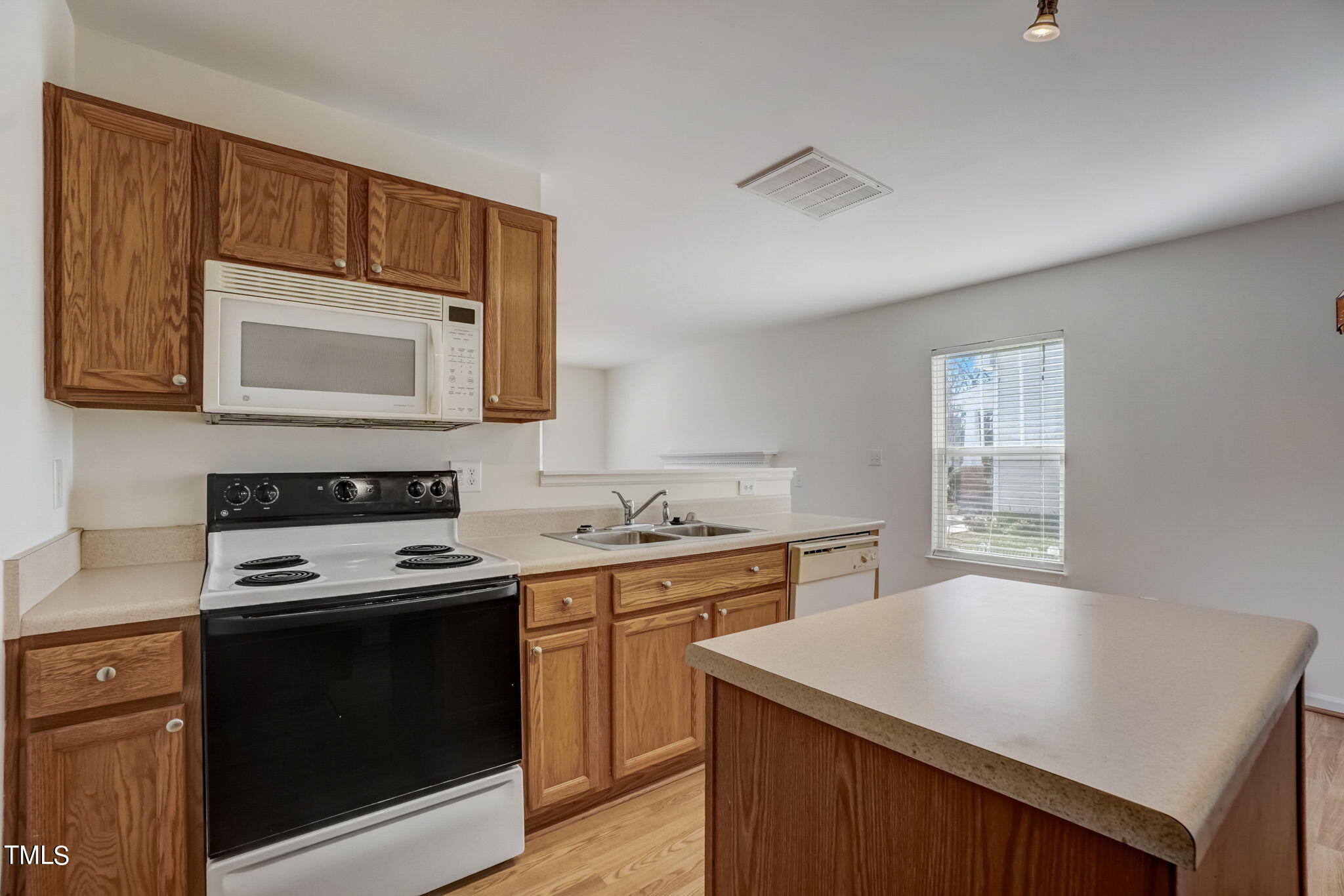 3705 Pinkham Way Raleigh, NC 27616 - Photo 12 of 29 a kitchen with a stove microwave and sink