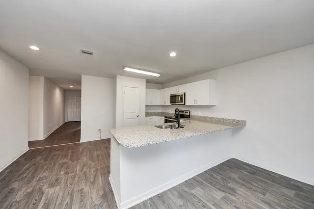 a kitchen with kitchen island sink refrigerator and stove