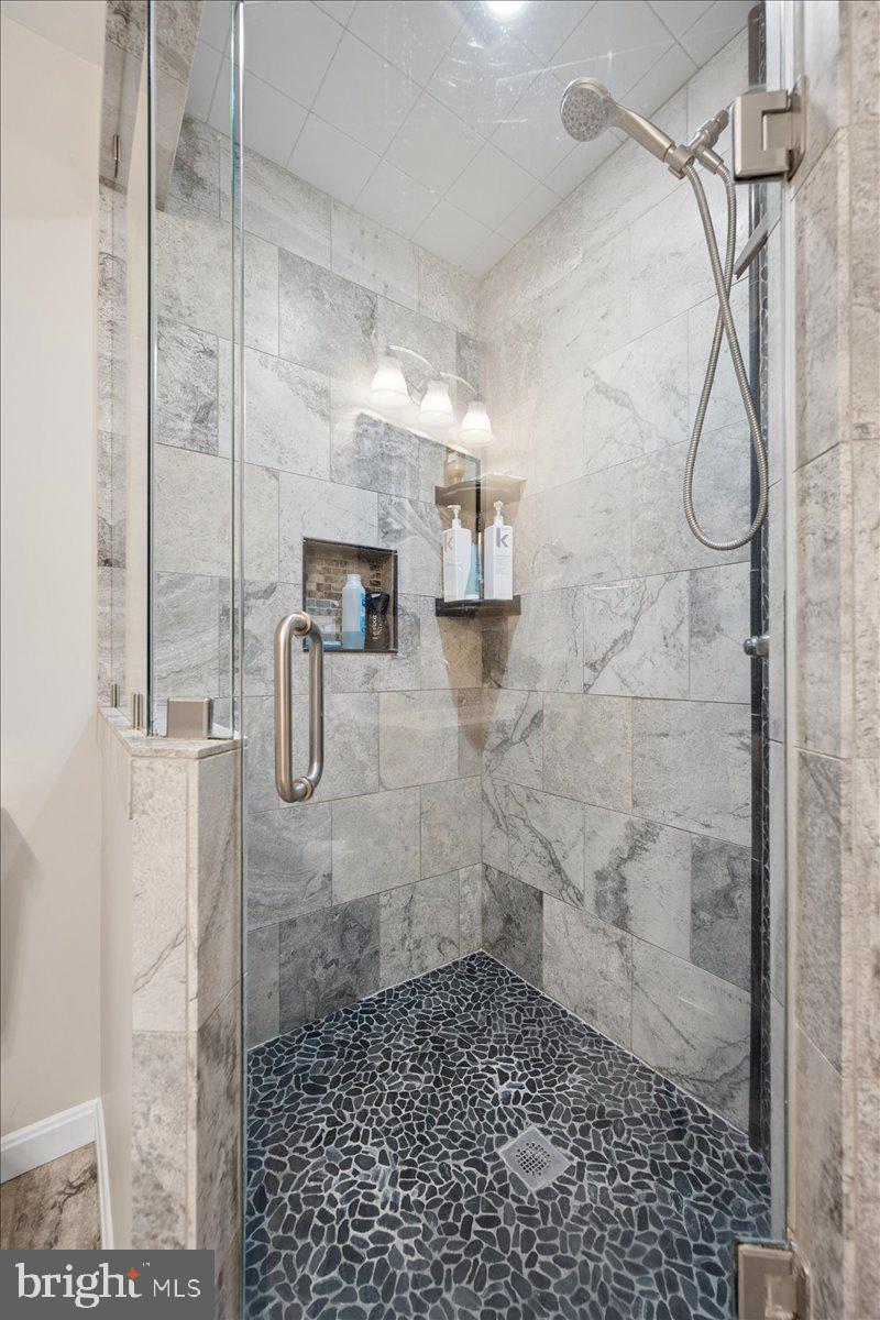 19829 Spurrier Avenue Poolesville, MD 20837 - Photo 20 of 72 Sleek modern shower with stone accents.