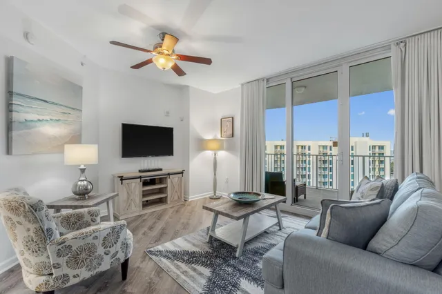 a large bed sitting in a bedroom and a chandelier