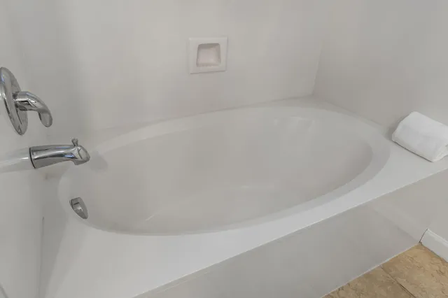 a bathroom with a sink a toilet a mirror and shower