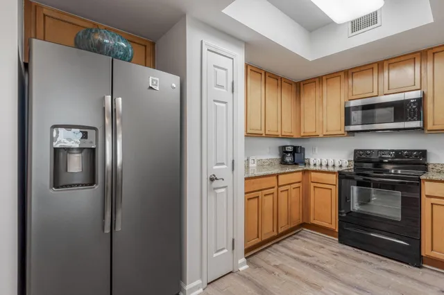 a kitchen with stainless steel appliances granite countertop a sink stove and microwave