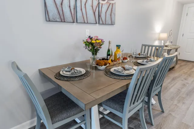 a living room with furniture a flat screen tv and a large window