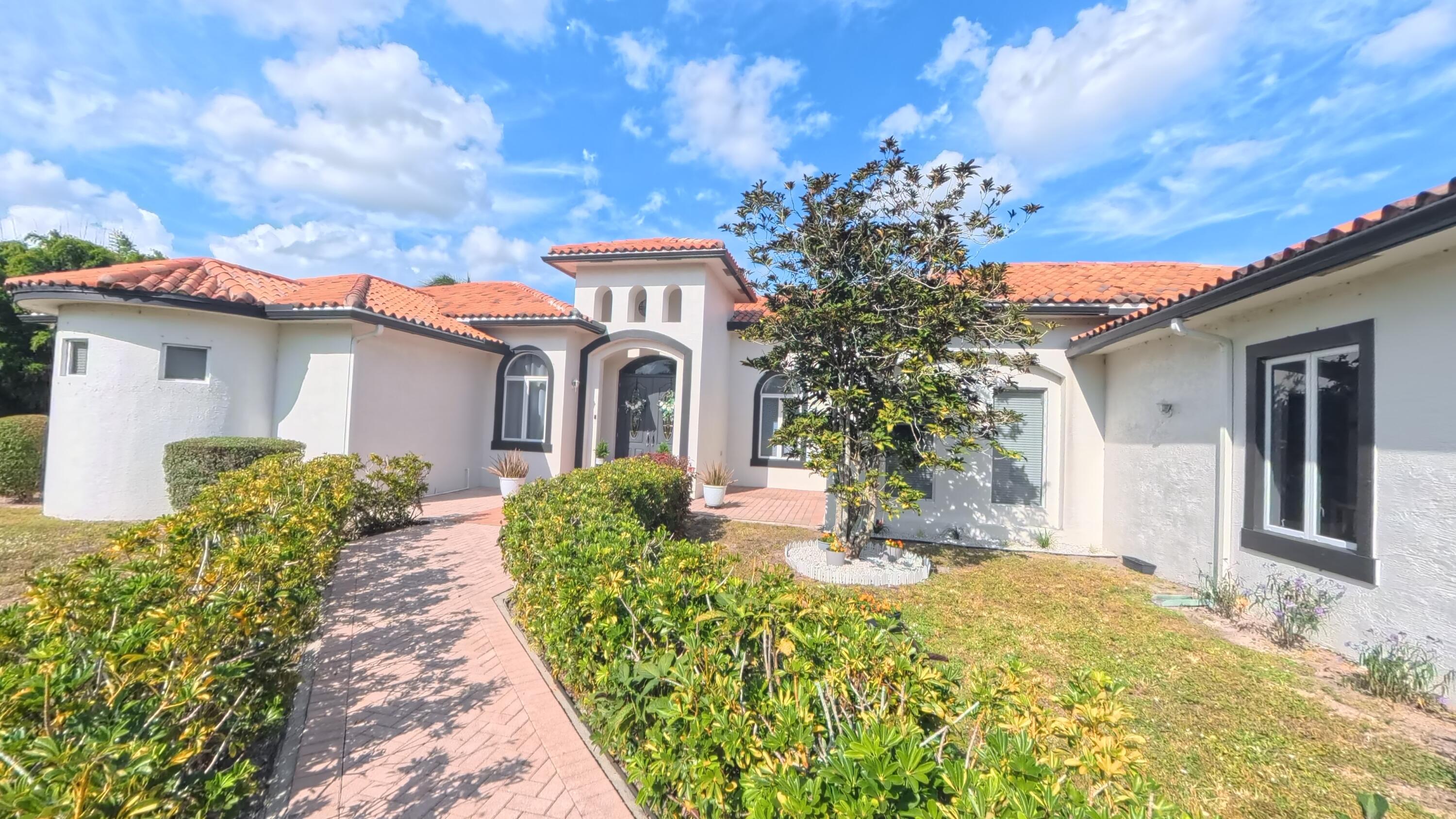 14225 43rd Road North Loxahatchee, FL 33470 - Photo 14 of 108 a front view of a house with a yard