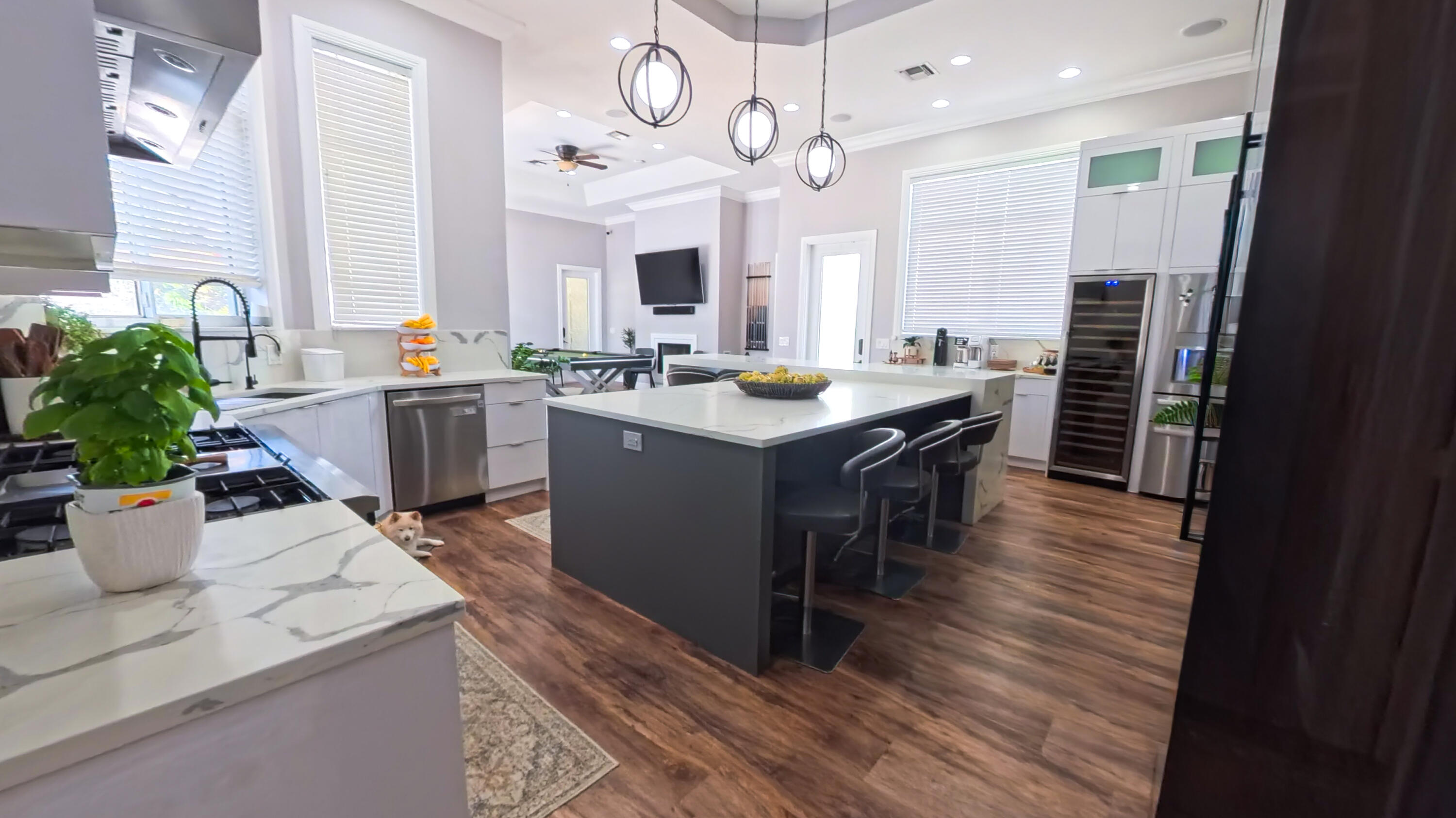 14225 43rd Road North Loxahatchee, FL 33470 - Photo 25 of 108 a room with stainless steel appliances kitchen island granite countertop a table chairs and a refrigerator