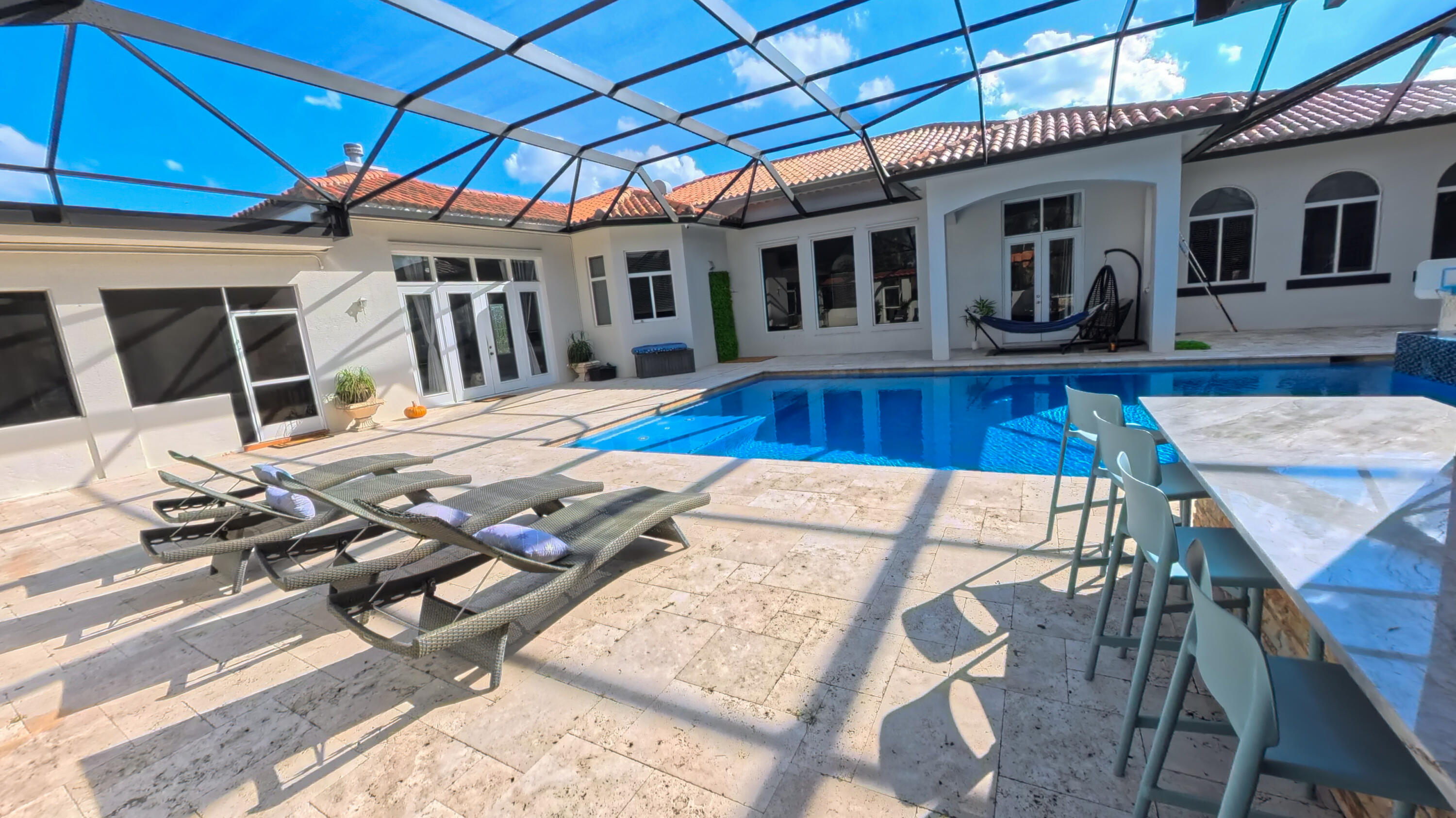 14225 43rd Road North Loxahatchee, FL 33470 - Photo 71 of 108 a view of a patio with table and chairs with wooden floor