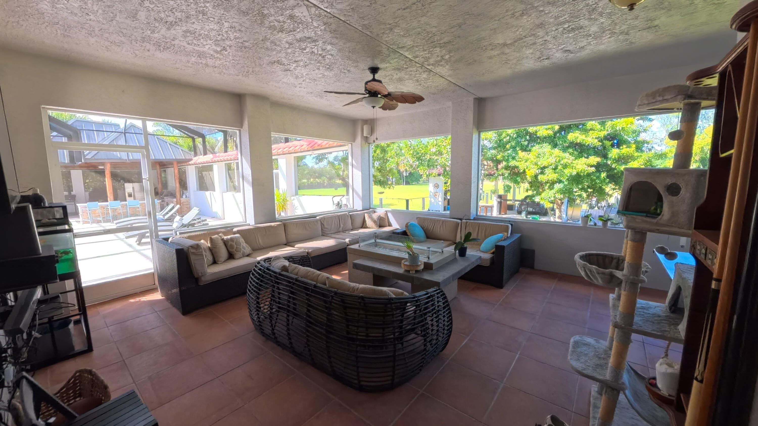 14225 43rd Road North Loxahatchee, FL 33470 - Photo 87 of 108 a living room with furniture a flat screen tv and a floor to ceiling window
