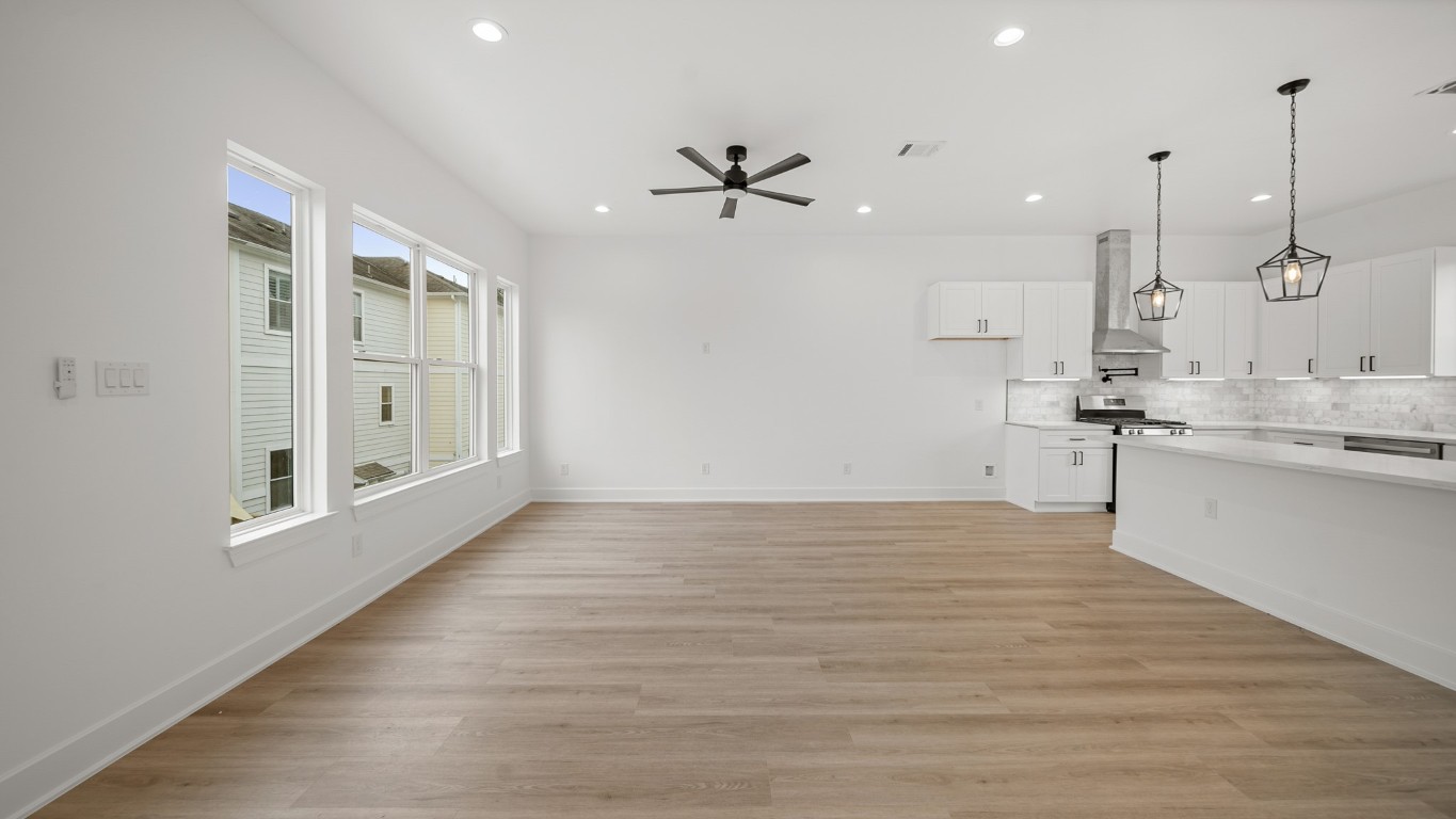 1908 Wheeler Avenue Houston, TX 77004 - Photo 19 of 43 a view of a kitchen with kitchen island a sink wooden floor and a large window