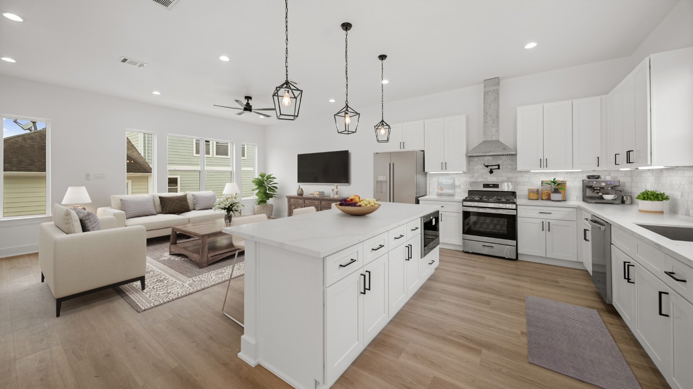 1908 Wheeler Avenue Houston, TX 77004 - Photo 20 of 43 a kitchen with white cabinets and stainless steel appliances