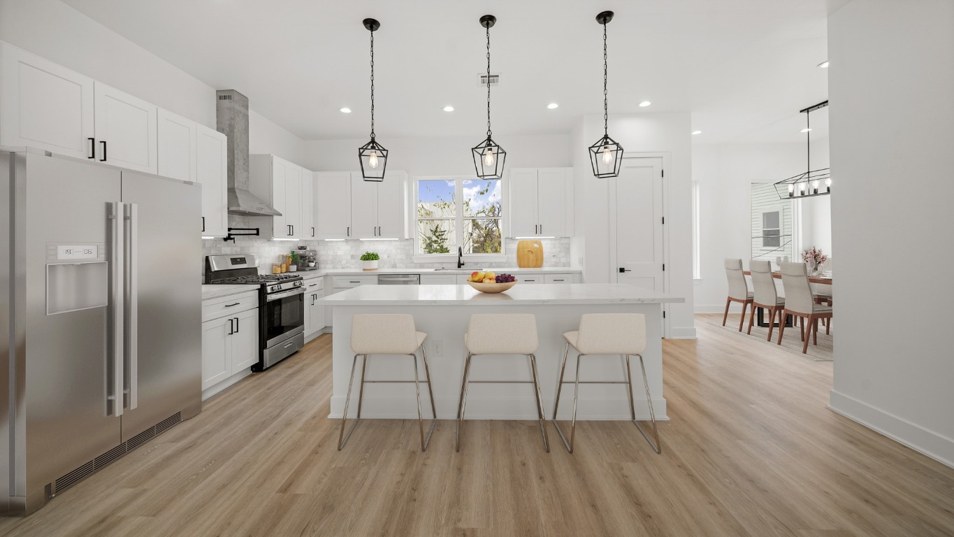 1908 Wheeler Avenue Houston, TX 77004 - Photo 21 of 43 a kitchen with white cabinets and stainless steel appliances