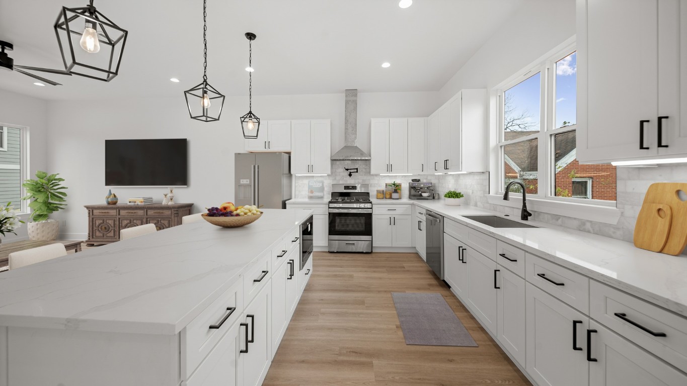 1908 Wheeler Avenue Houston, TX 77004 - Photo 23 of 43 a large kitchen with cabinets a sink and a stove top oven with wooden floor
