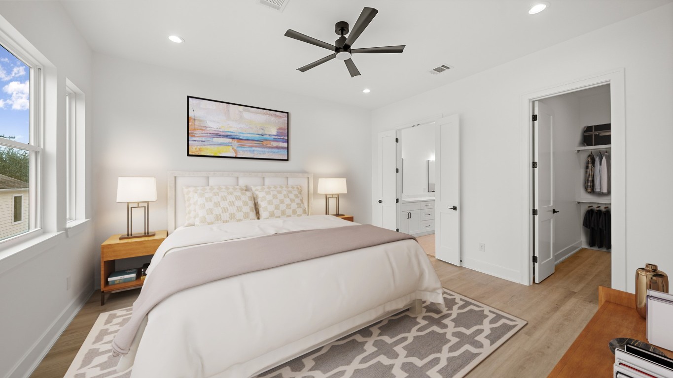 1908 Wheeler Avenue Houston, TX 77004 - Photo 30 of 43 a spacious bedroom with a bed and a chandelier