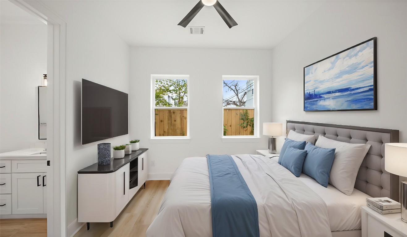 1908 Wheeler Avenue Houston, TX 77004 - Photo 10 of 43 a bedroom with furniture and a flat screen tv