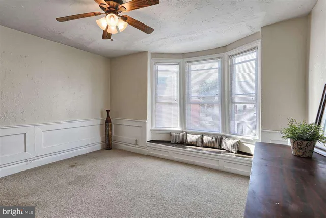 a spacious bedroom with a bed and a chandelier