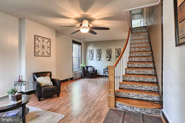 a living room with furniture and wooden floor