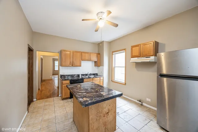 a kitchen with a refrigerator a stove a sink and a refrigerator