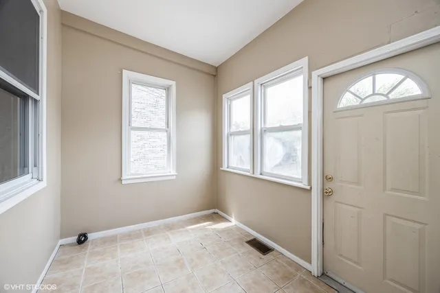 an empty room with windows and closet