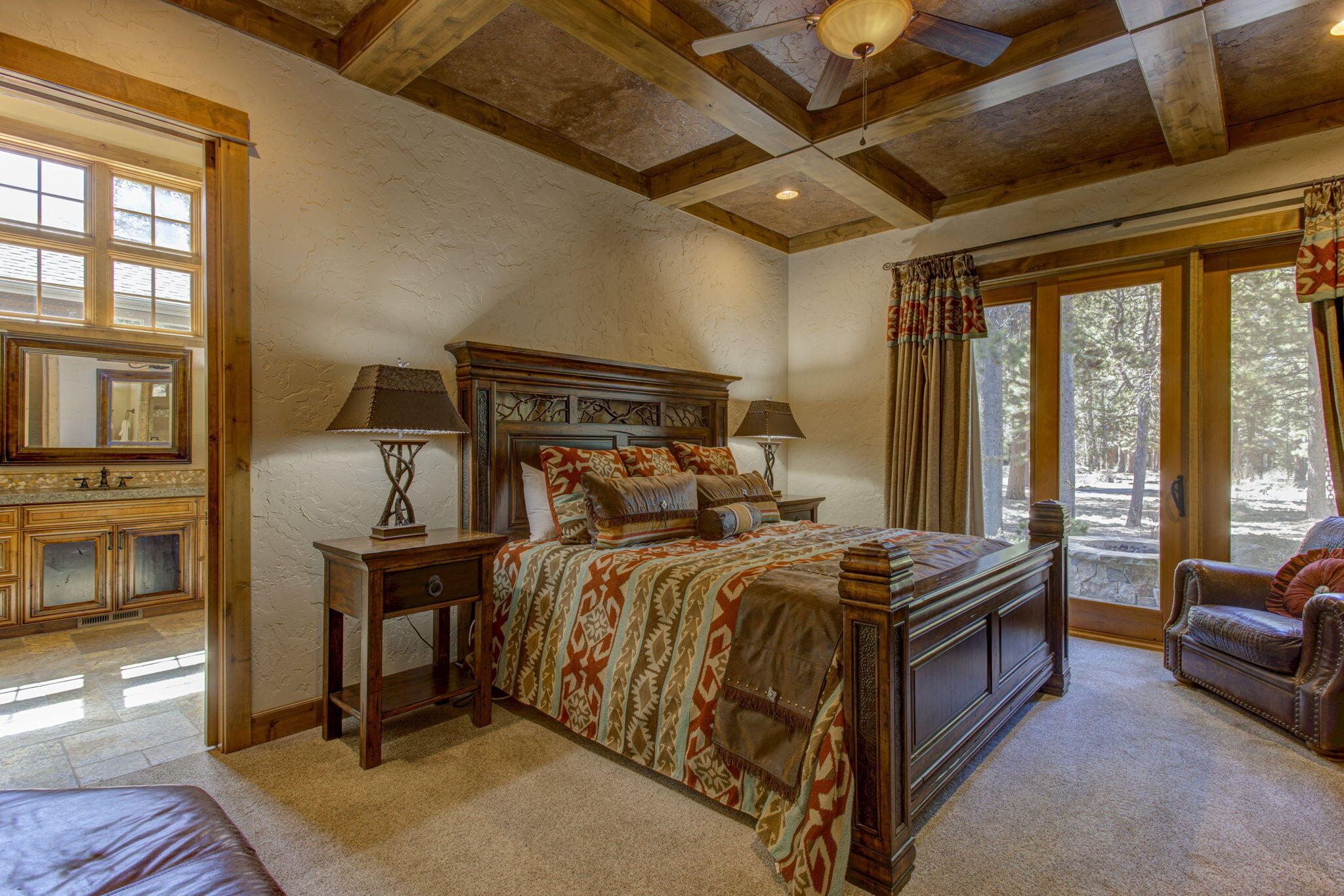 56184 Sable Rock Loop Bend, OR 97707 - Photo 30 of 72 Stunning primary bedroom on the main with solid wood coffered ceiling and doors to the hot tub on back patio facing Sable Rock pond and stream