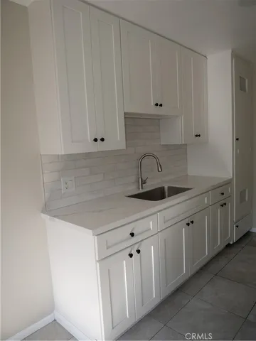 a kitchen with white cabinets