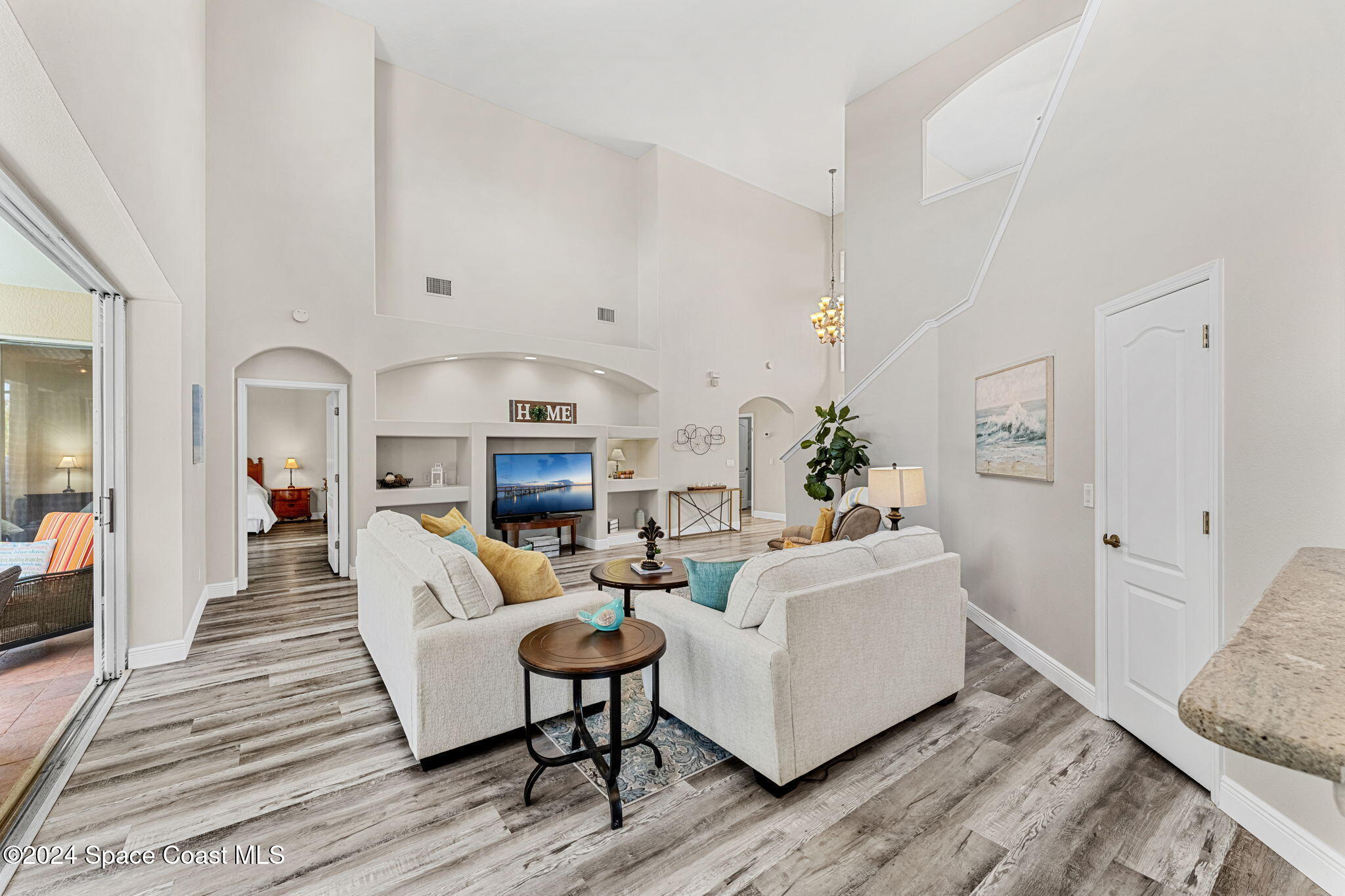 3416 Peninsula Circle Melbourne, FL 32940 - Photo 16 of 61 a living room with fireplace furniture and a wooden floor