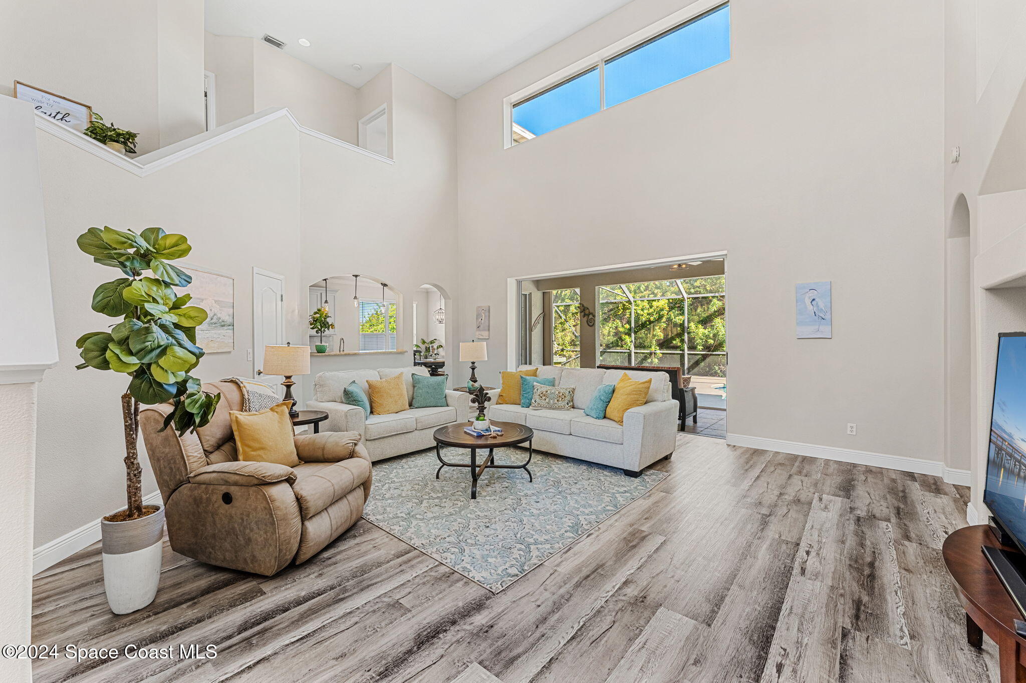 3416 Peninsula Circle Melbourne, FL 32940 - Photo 18 of 61 a living room with furniture and a wooden floor