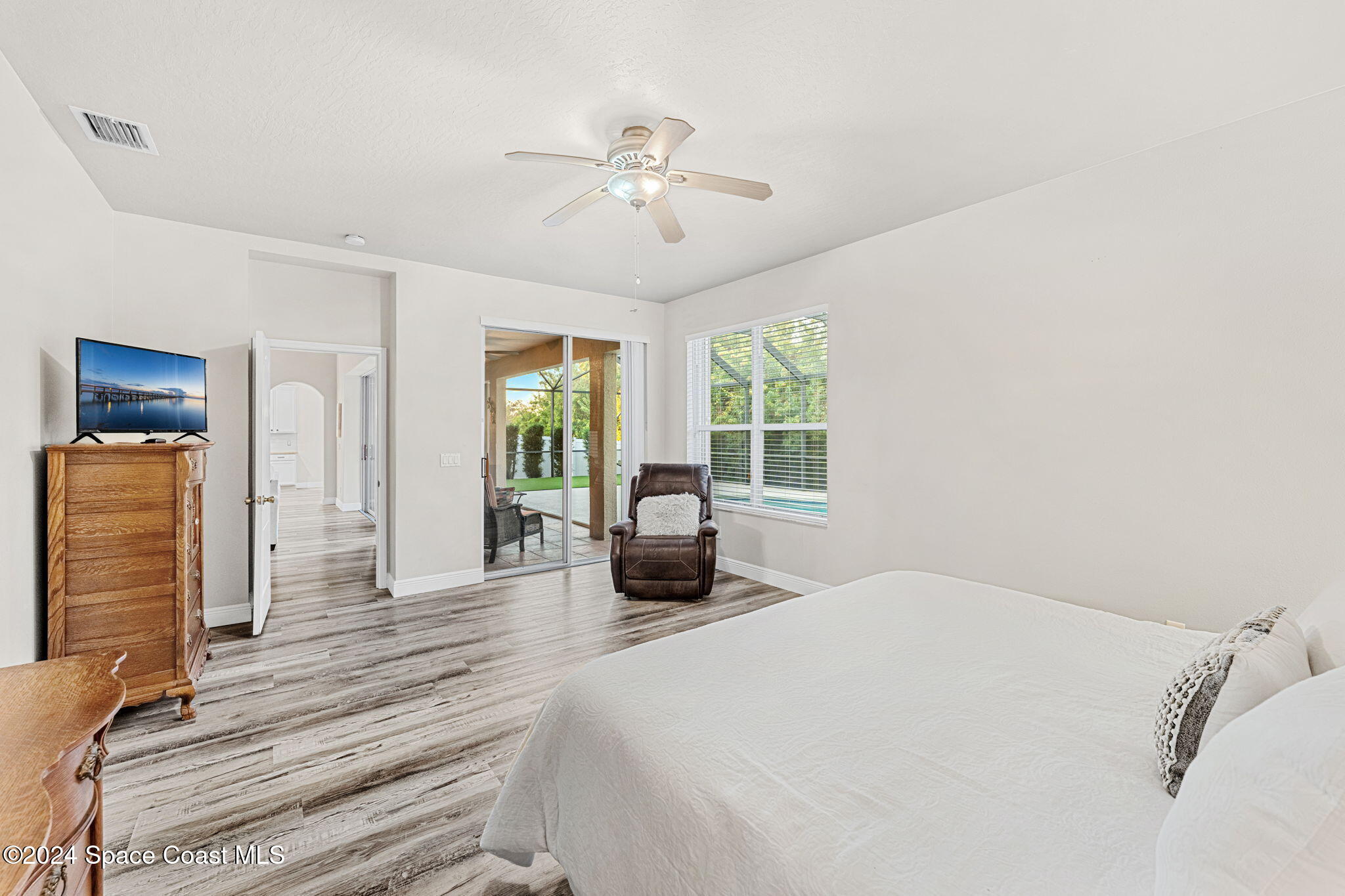 3416 Peninsula Circle Melbourne, FL 32940 - Photo 22 of 61 a bedroom with a bed and a large window