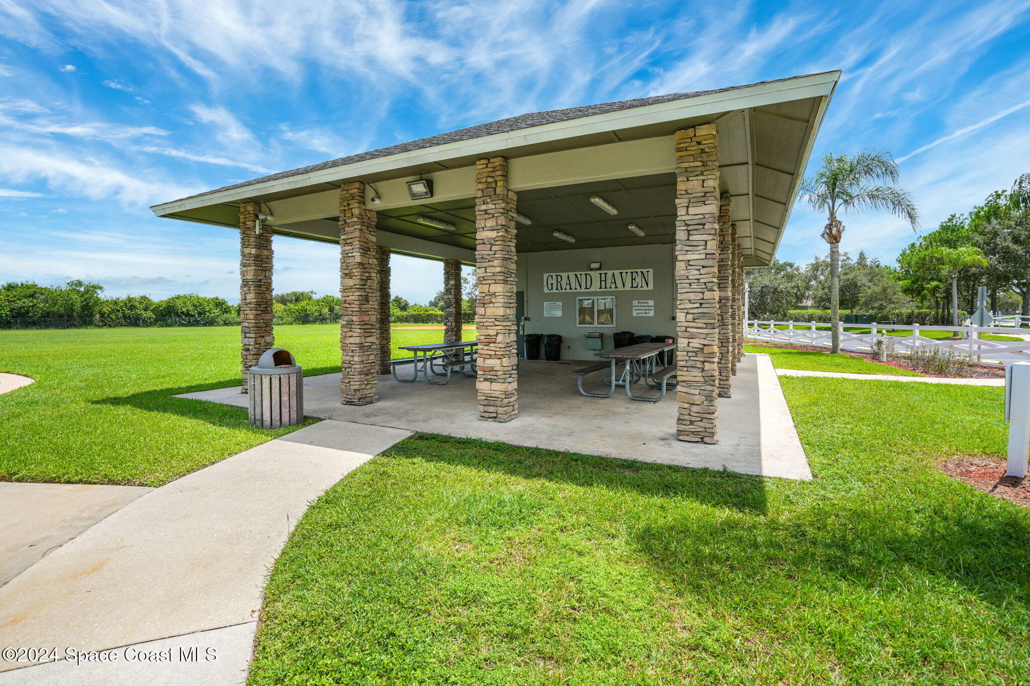 3416 Peninsula Circle Melbourne, FL 32940 - Photo 54 of 61 a view of a patio with table and chairs potted plants and floor to ceiling window