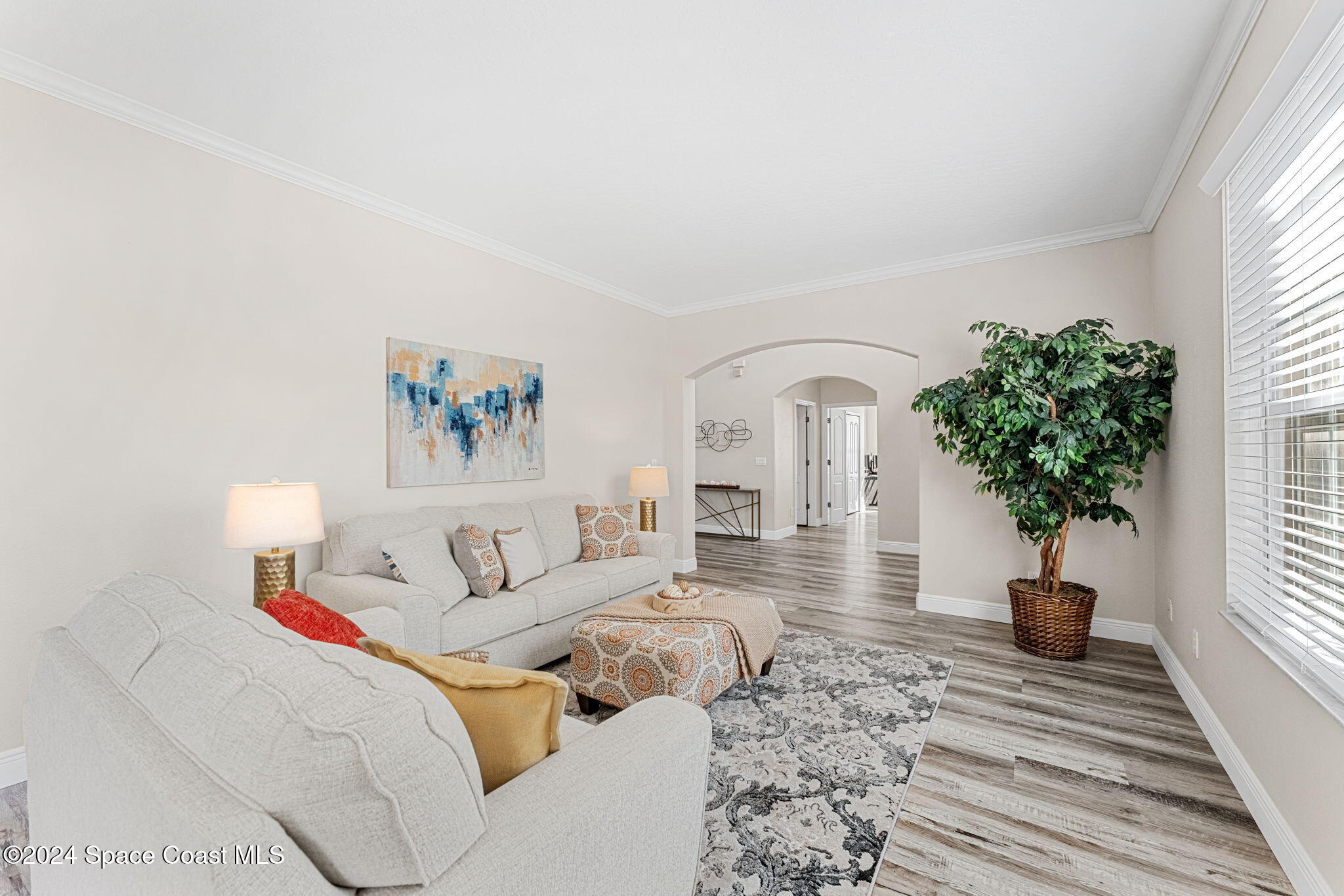 3416 Peninsula Circle Melbourne, FL 32940 - Photo 6 of 61 a living room with furniture and a potted plant