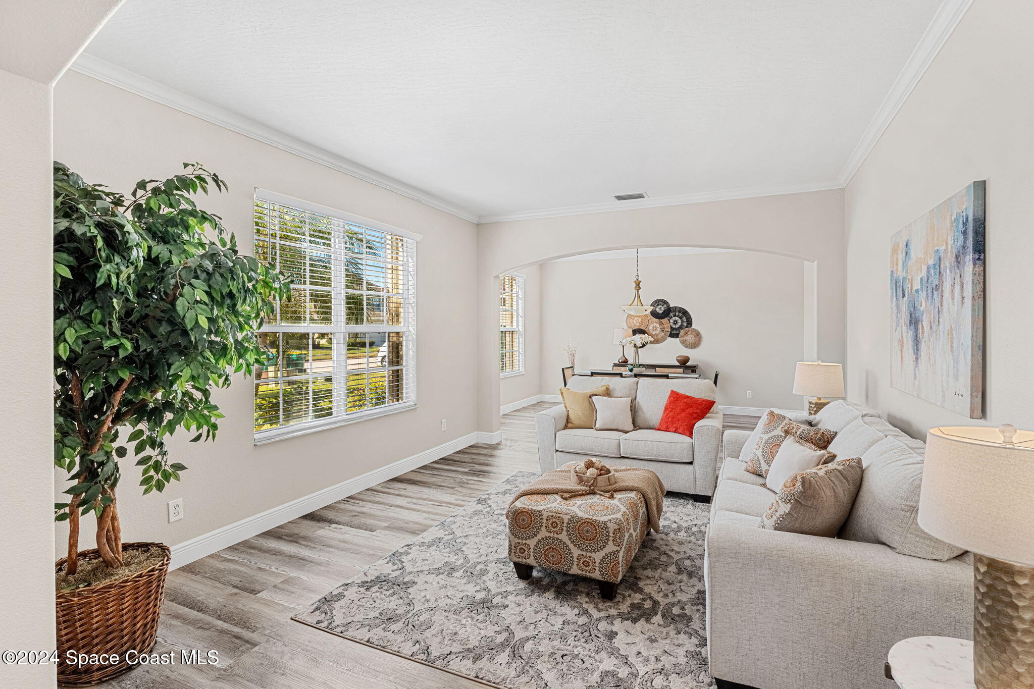 3416 Peninsula Circle Melbourne, FL 32940 - Photo 7 of 61 a living room with furniture and a potted plant