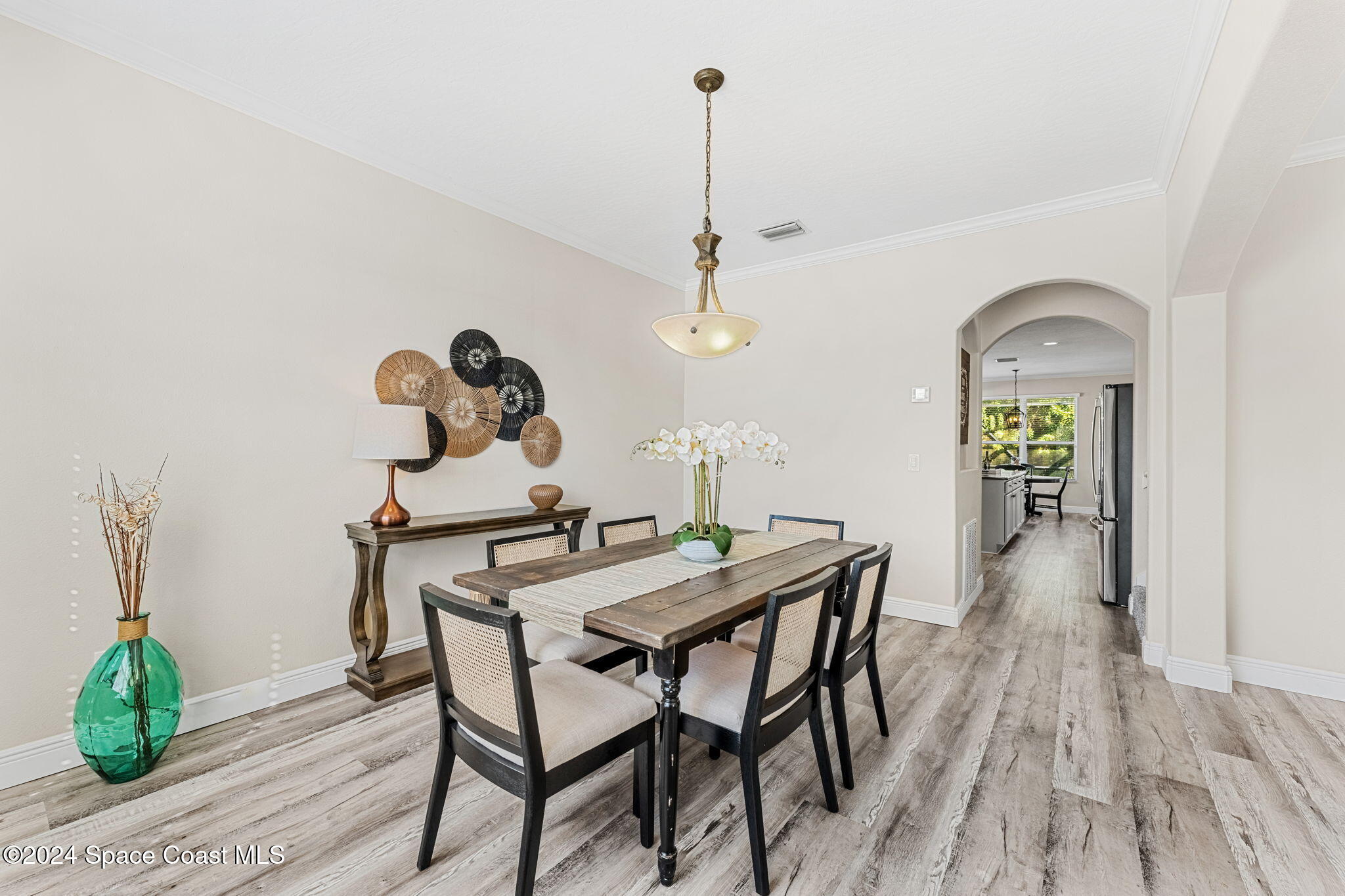 3416 Peninsula Circle Melbourne, FL 32940 - Photo 9 of 61 a view of a dining room with furniture and wooden floor