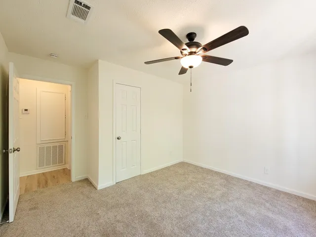 a view of a ceiling fan and a ceiling fan in a room