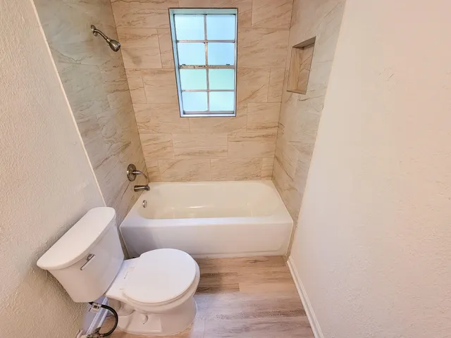 a bathroom with a toilet and a bathtub