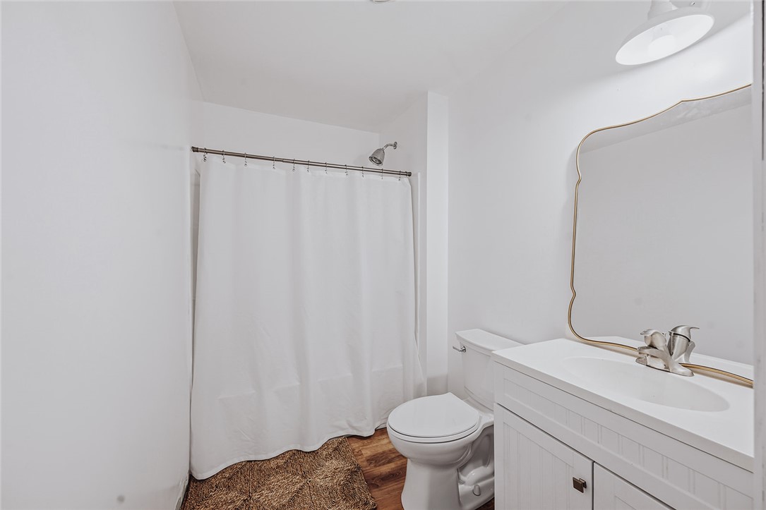 209 Cleveland Pike Road Westminster, SC 29693 - Photo 18 of 30 A well-appointed bathroom features a shower, toilet, and a vanity with a sleek sink.
