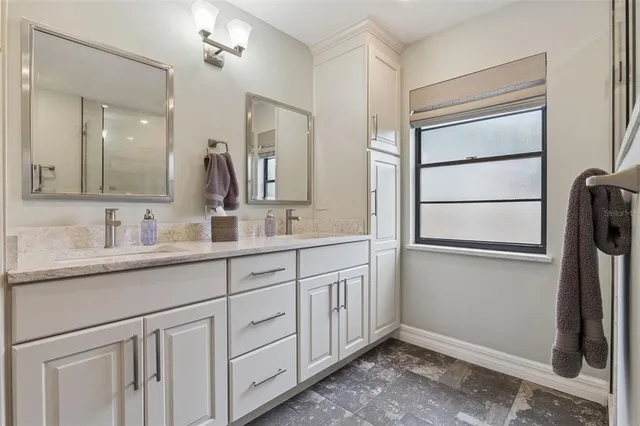 a bathroom with a double vanity sink and mirror