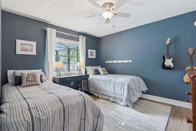 a bedroom with two beds and a window