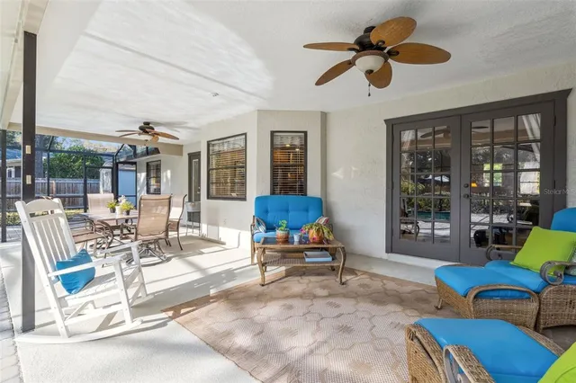 a living room with furniture ceiling fan and a window