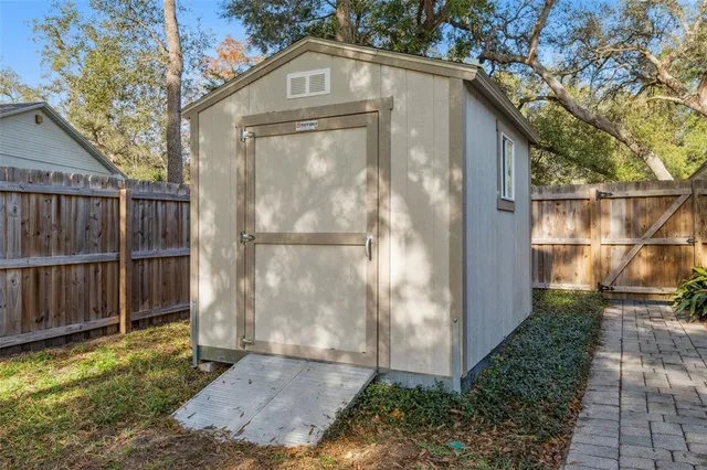 a view of a entrance gate of the house and trees